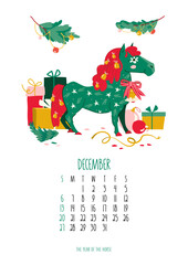 December 2026 monthly calendar template featuring a festive green horse mascot decorated with stars and bells, surrounded by colorful Christmas gift boxes and holiday pine branches