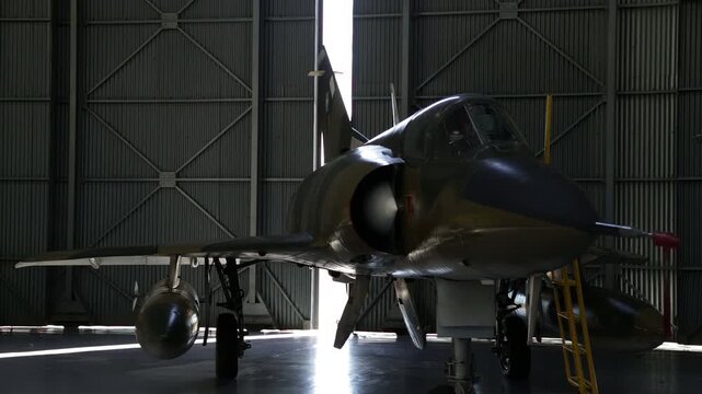 Fighter Jet Inside Military Hangar, Door Opening With Daylight, Dramatic Light