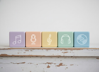Pastel colored cubes with music symbols. Educational toy for children. Concept of early music education and sensory development.