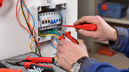 electrician fixing electrical wires in main fuse box  © Jakub