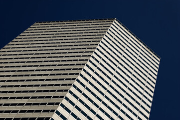 Modern Office Tower: Contemporary Skyscraper with Glass Facade Rising in Business District