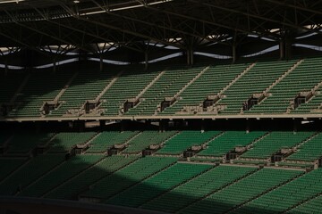 Empty stadium with green seats and modern architecture