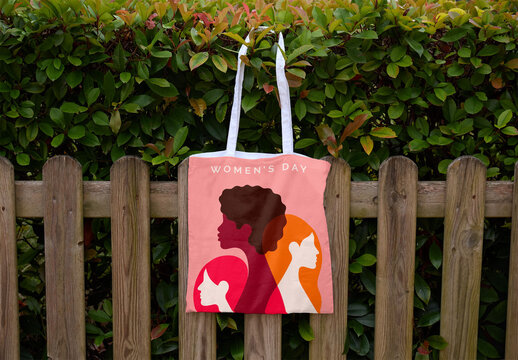 Simple White Tote Bag Hanging on a Fence. PSD template mockup.