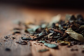 Macro photograph of tea leaves spread on a rustic wooden table, earthy tones and calm mood