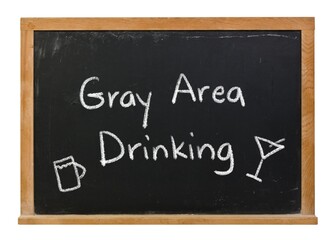 Gray Area Drinking handwritten in white chalk on a black chalkboard isolated in a wooden frame on white