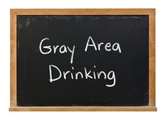 Gray Area Drinking handwritten in white chalk on a black chalkboard isolated in a wooden frame on white