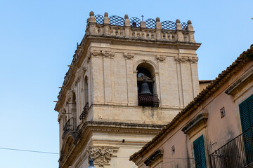 Catholic church facade under bright blue sky