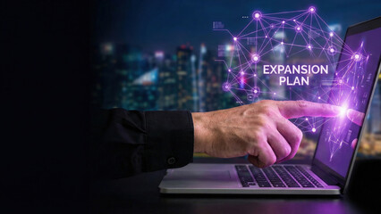 Business hand high level planning expansion plan concept glowing on laptop screen