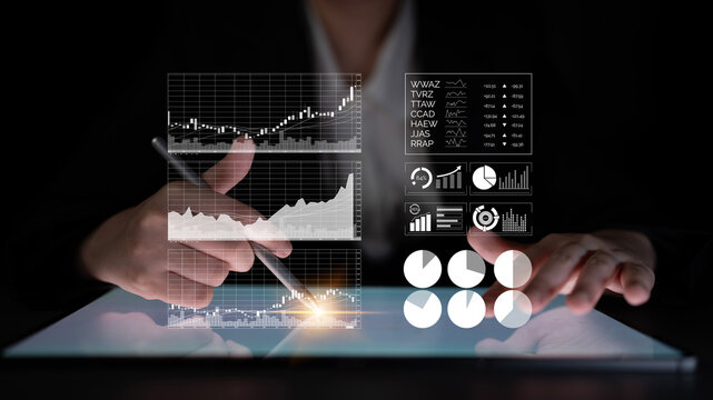 A business professional is using a touchscreen device to analyze data trends and financial insights in a dimly lit environment, emphasizing technology and innovation. Impute - Powered by Adobe