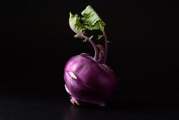 Ripe purple kohlrabi, freshly harvested from an organic farm, placed on a black background, is a healthy ingredient for cooking