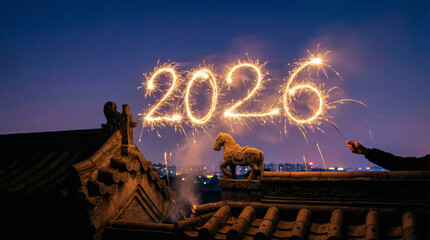 Night view of a hand holding a sparkler to write the year 2026 in glowing light above a traditional tiled roof featuring a horse statue, symbolizing the Year of the Horse celebration.