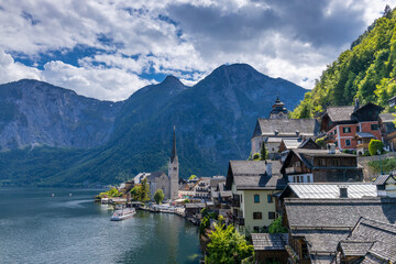 Fototapeta premium Hallstatt village in Austria on the shore of alpine lake. Historic village and mountain landscape. Traditional architecture scenic waterfront and natural surroundings popular tourist destination