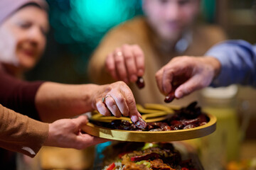 Fototapeta premium Gathering around a table to share dates during iftar in a home filled with Ramadan spirit and family bonds
