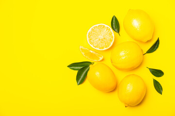 Lemon on a wooden table. Fresh lemon with a slice. Fresh lemon with citrus leaves. Lemon juice. Food and drink ingredients preparing. Healthy eating. Vitamin C. Space for text.