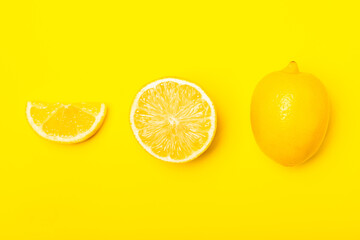 Lemon on a wooden table. Fresh lemon with a slice. Fresh lemon with citrus leaves. Lemon juice. Food and drink ingredients preparing. Healthy eating. Vitamin C. Space for text.