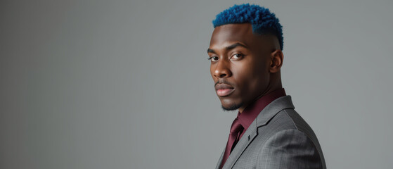 Obraz premium Stylish man with blue hair wearing gray suit and maroon shirt, exuding confidence and modern fashion