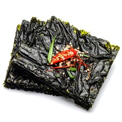 Stacked sheets of savory seaweed snacks, seasoned with chili peppers and sprinkled with seeds, shot against a white backdrop