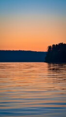 Serene lake at sunset with vibrant sky and trees