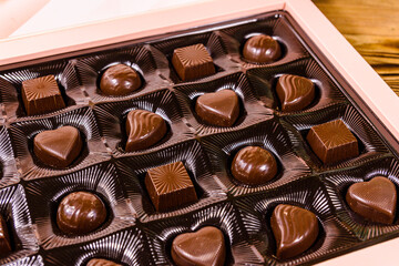 Heap of chocolate candies in a brown box