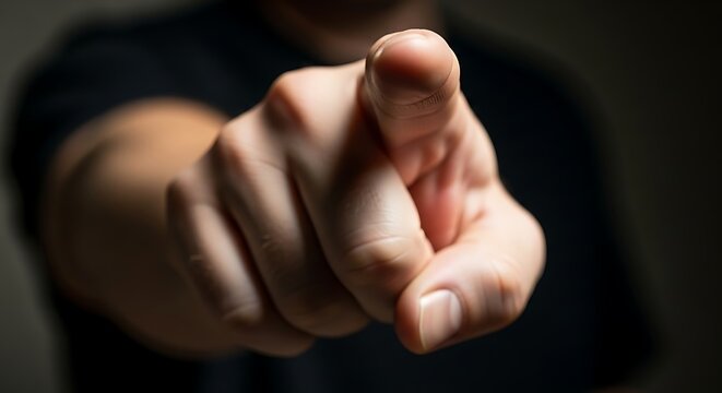 Close up of a hand pointing forward.
