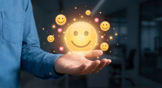 person holding glowing smiley face with floating emojis - Powered by Adobe