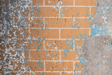 Peeling paint on the wall. Old concrete wall with cracked flaking paint. Weathered rough painted surface with patterns of cracks and peeling. Grunge texture for background and design. High resolution.