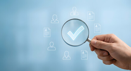 Hand holding magnifying glass with check mark and icons