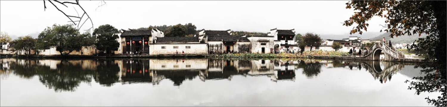 Panorama of traditional Chinese Hui-style architecture village with reflection in lake, Hongcun, Anhui.