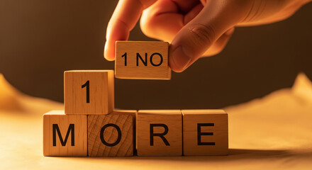 Wooden blocks with text "1 MORE" and hand placing "1 NO" block, representing message or concept of negation, rejection, or change in direction