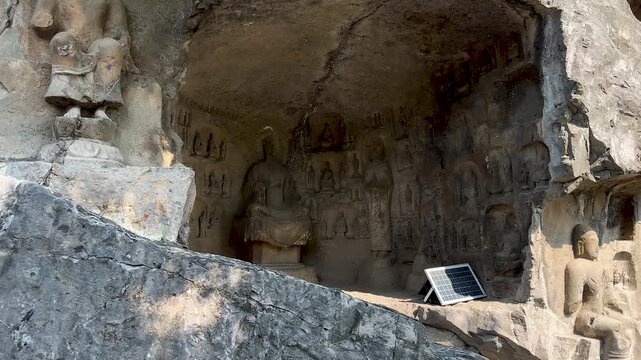 Statues of Uddiyana (or Oddiyna) Buddhist sculpture style on cliffs between Binyang Cave and Jingshan Temple Cave and around,  at Longmen Grottoes, Luoyang, Henan, China. UNESCO World Heritage site.