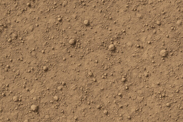 Close-up of dry cracked earth with small pebbles and dirt