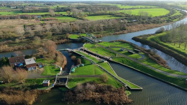 Aerial drone view of inland river canal and water control facility, sluice gates and lock gates, abstraction of water, Denver Sluice complex England UK 