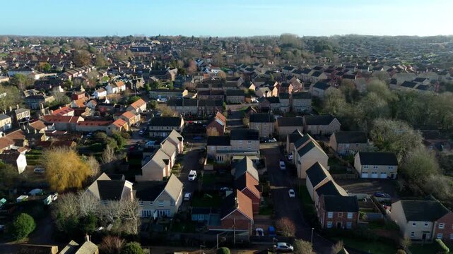 Aerial drone view of Downham Market, residential suburbs and housing in bright winter sunlight. cars parked outside houses. United Kingdom.  