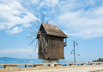 NESEBAR, BULGARIA - JUNE 07, 2019: windmill and road to old historical centre of the town Nesebar, UNESCO World heritage site, and view on the new Nesebar.