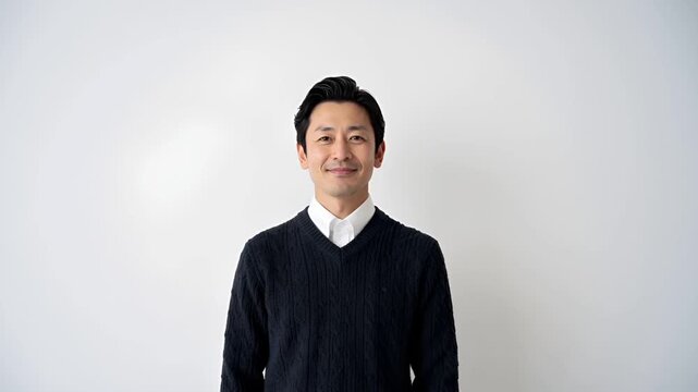 白背景のスタジオで撮影された日本人男性の上半身ポートレート。
ニットセーター姿で、IT・企画・コンサル業界を想起させる清潔感ある印象。
柔らかなライティングと浅い被写界深度により、信頼感と親しみやすさを表現。
