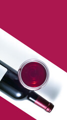 A glass and a bottle of red wine on a white background. Red background for text.