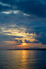 sunrise with a view of the smokestacks of the Steam Power Plant and the mountains in the distance.