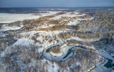 Aerial photo of Koen river under ice and snow. Beautiful winter landscape.