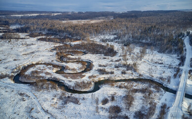 Aerial photo of Koen river and road bridge under ice and snow. Beautiful winter landscape.