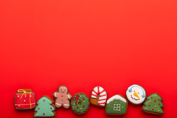 Christmas gingerbread cookies on red background copy space