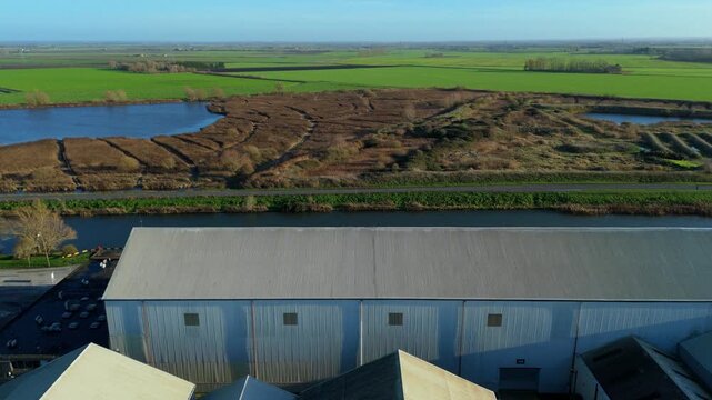 Aerial view of marshland and lake habitat, reed beds and blue water in fenland near Ely, United Kingdom. 
