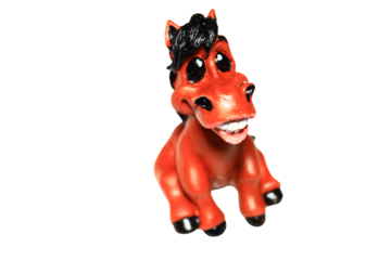 A toy horse sitting on a white surface, ideal for decorative or educational purposes