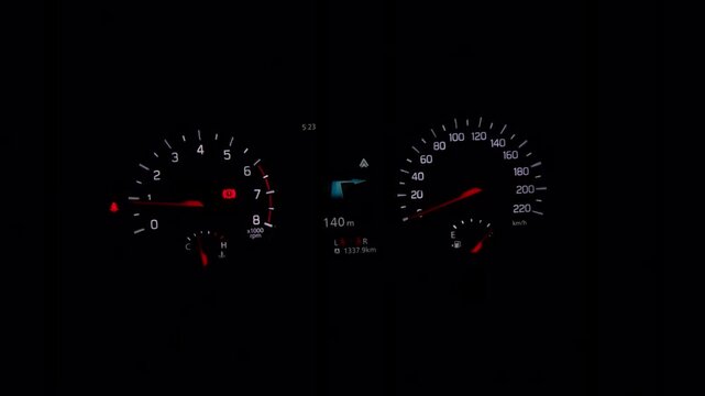 Nighttime driving scene features a glowing car dashboard with analog gauges and a digital screen, representing automotive technology and road travel.