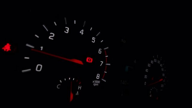 Nighttime driving scene features a glowing car dashboard with analog gauges and a digital screen, representing automotive technology and road travel.