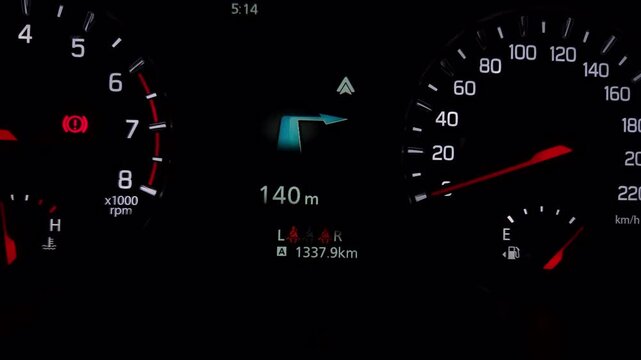 Nighttime driving scene features a glowing car dashboard with analog gauges and a digital screen, representing automotive technology and road travel.