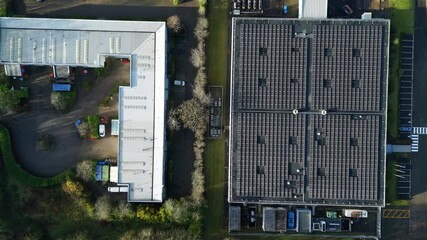 Aerial drone view of large scale data centre, Quantum computing and cloud storage, solar panels on roof for energy, cooling fans and ventilation in Milton Keynes, UK. - Powered by Adobe