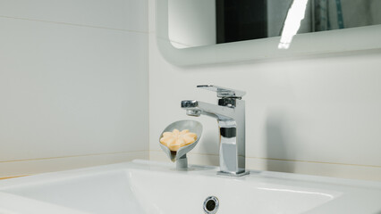 Modern bathroom sink with chrome faucet and soap holder