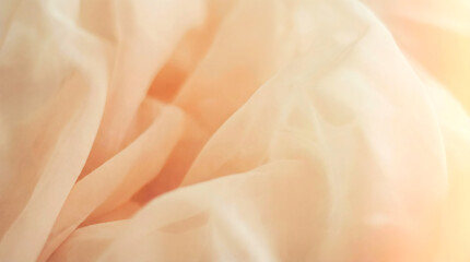 Fototapeta premium Soft peach fabric with gentle folds and a warm, ethereal glow