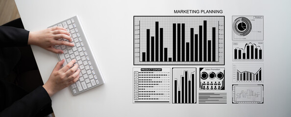 A detailed workspace showcasing marketing planning through various statistics and graphs with a sleek keyboard, illustrating a blend of professionalism and creativity in data analysis. Impute