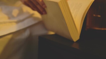 Books on wooden table with warm lighting for bedtime reading and learning